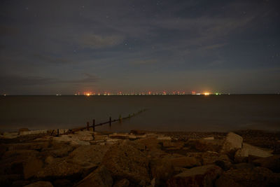 Scenic view of sea against sky at night