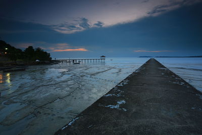 Pier over sea against sky