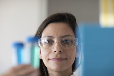 Scientist female with lab glasses and sample in a lab