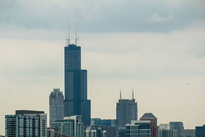 Skyscrapers in city against sky