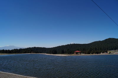Scenic view of mountains against clear blue sky