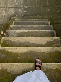 Low section of man standing on staircase
