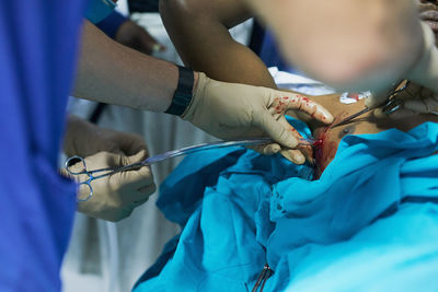 Midsection of doctor examining patient