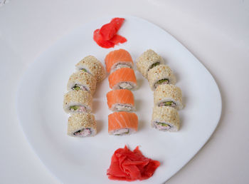 High angle view of fish on plate against white background