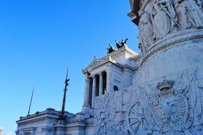Low angle view of statue against blue sky