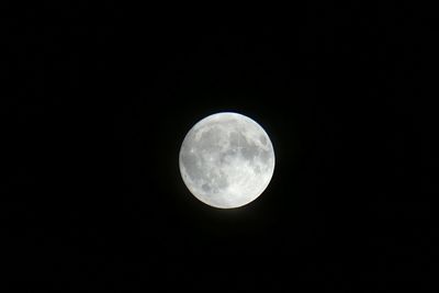 Low angle view of moon against clear sky at night