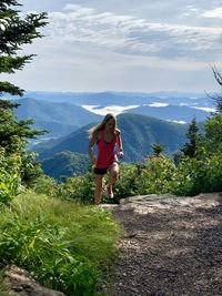 Full length of woman on mountains against sky