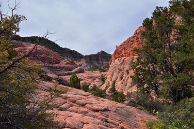 Low angle view of rocky mountains against sky