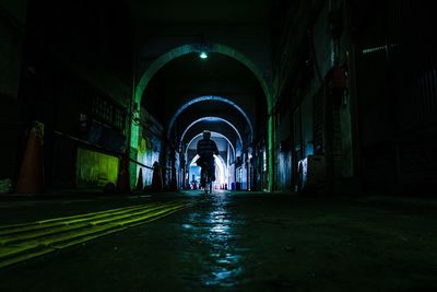 Low angle view of illuminated tunnel in building