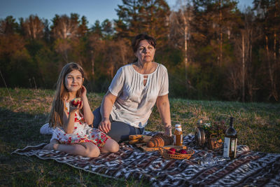 Young woman sitting on table in back yard