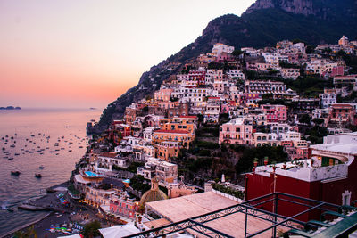 High angle view of townscape by sea against sky