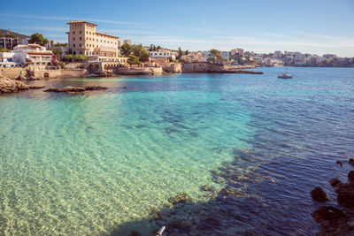 Scenic view of sea and buildings against sky