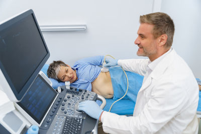 Young man using laptop at clinic