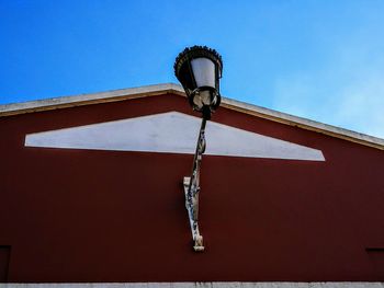 Low angle view of cross against sky