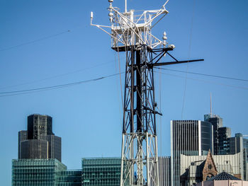 Low angle view of communications tower against clear sky