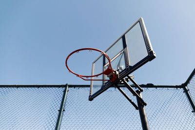 Low angle view of basketball hoop against clear sky