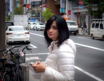 Portrait of woman on street in city