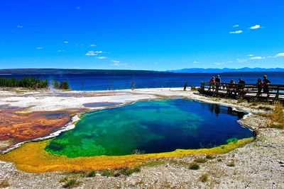 Tourists at abyss pool in west thumb geyser basin