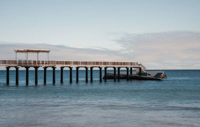 Pier over sea against sky