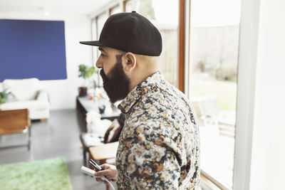 Side view of male architect at home office