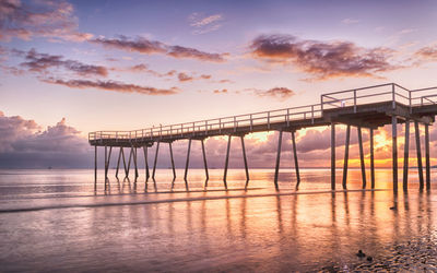 Scenic view of pier against sky during sunset