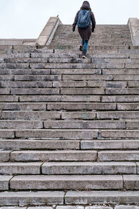 Woman on steps against sky