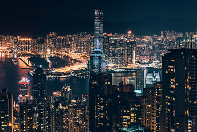 Illuminated cityscape against sky at night