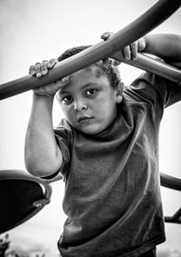Low angle portrait of boy playing at playground
