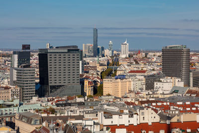 High angle view of modern buildings in city against sky