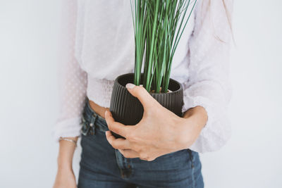 Midsection of woman holding plant