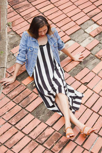 High angle view of woman sitting outdoors