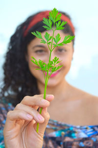 Close-up of woman holding plant