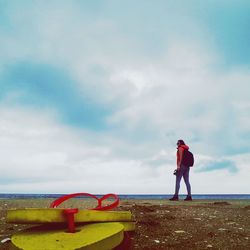 Man standing by sea against sky