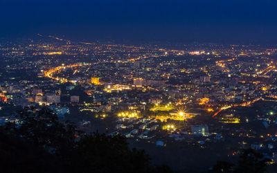 High angle view of illuminated buildings in city at night