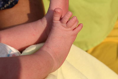 Low section of newborn lying on bed