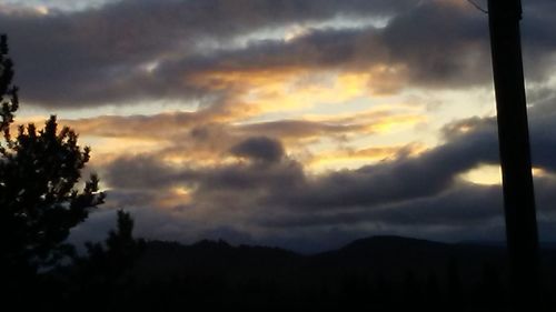 Scenic view of silhouette mountains against sky at sunset