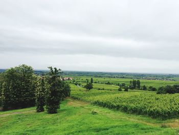 Scenic view of field against cloudy sky