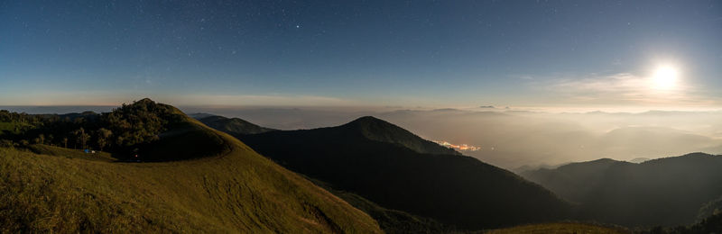 Scenic view of mountains against sky at night