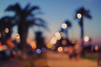 Defocused image of illuminated street lights in city at night