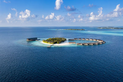 Bungalows surrounded by blue sea view at kudadoo island, maldives