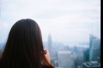 Rear view of woman looking at cityscape