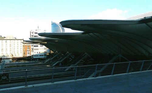 Statue in city against sky