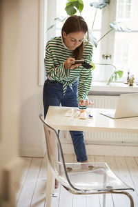 Young woman sitting on chair at home