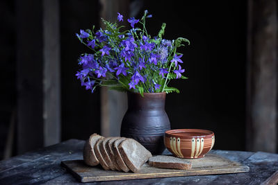 Close-up of purple flower in pot on table