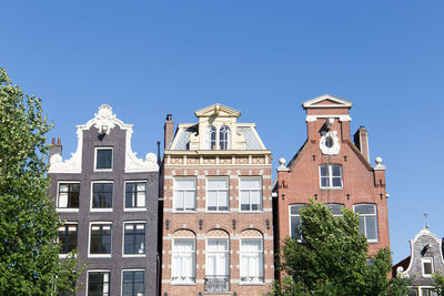 Low angle view of building against clear blue sky