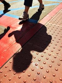 Low section of person shadow on floor