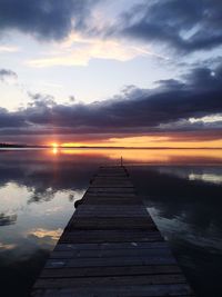 Wooden jetty on pier at sunset