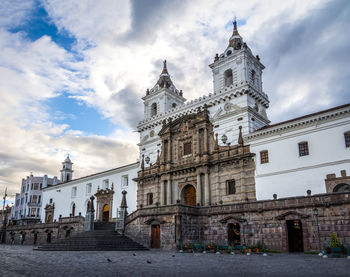 Low angle view of historic building against cloudy sky