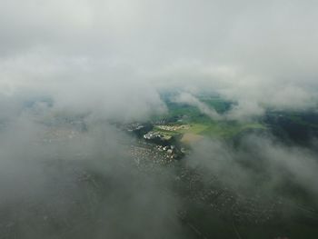 Aerial view of town seen through clouds