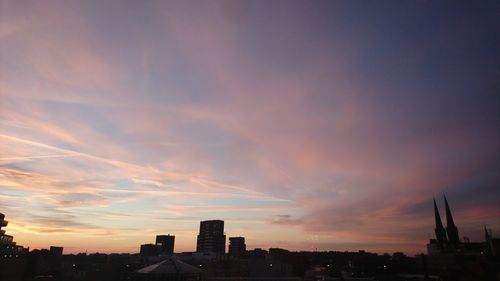 Silhouette buildings against sky during sunset